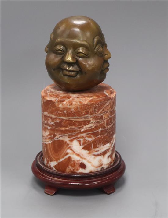 An Eastern bronze four mask Buddhistic head, on marble socle height 28cm. incl. wood stand